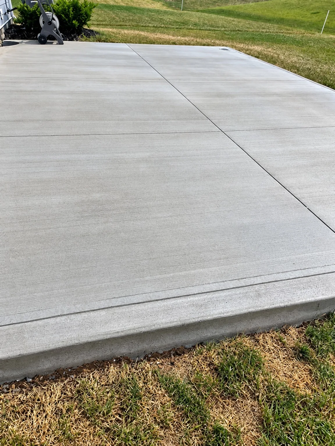 Finished smooth residential concrete driveway with expansion joints